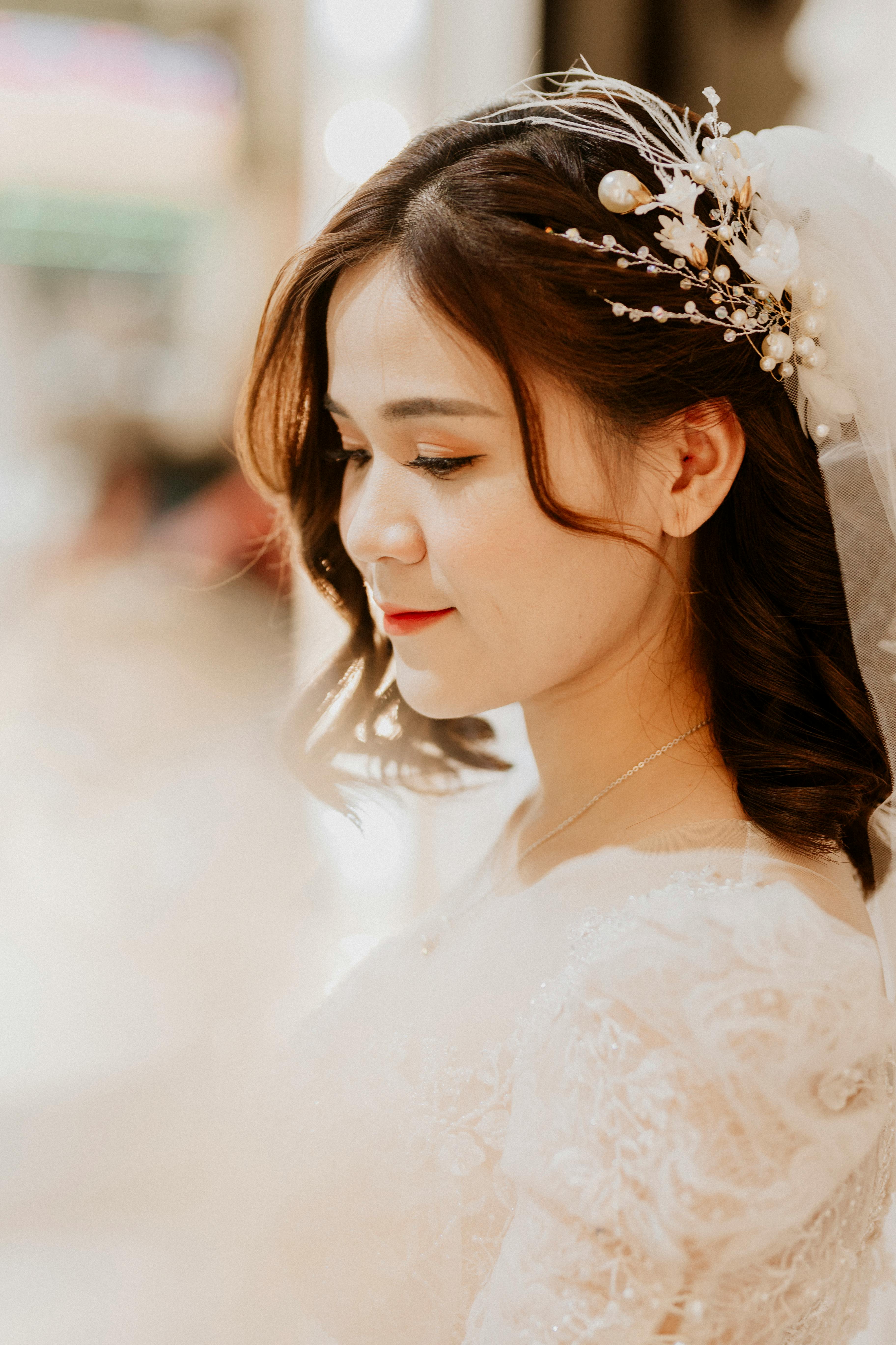An elegant close-up of a bride showcasing her intricate hairstyle and serene expression.