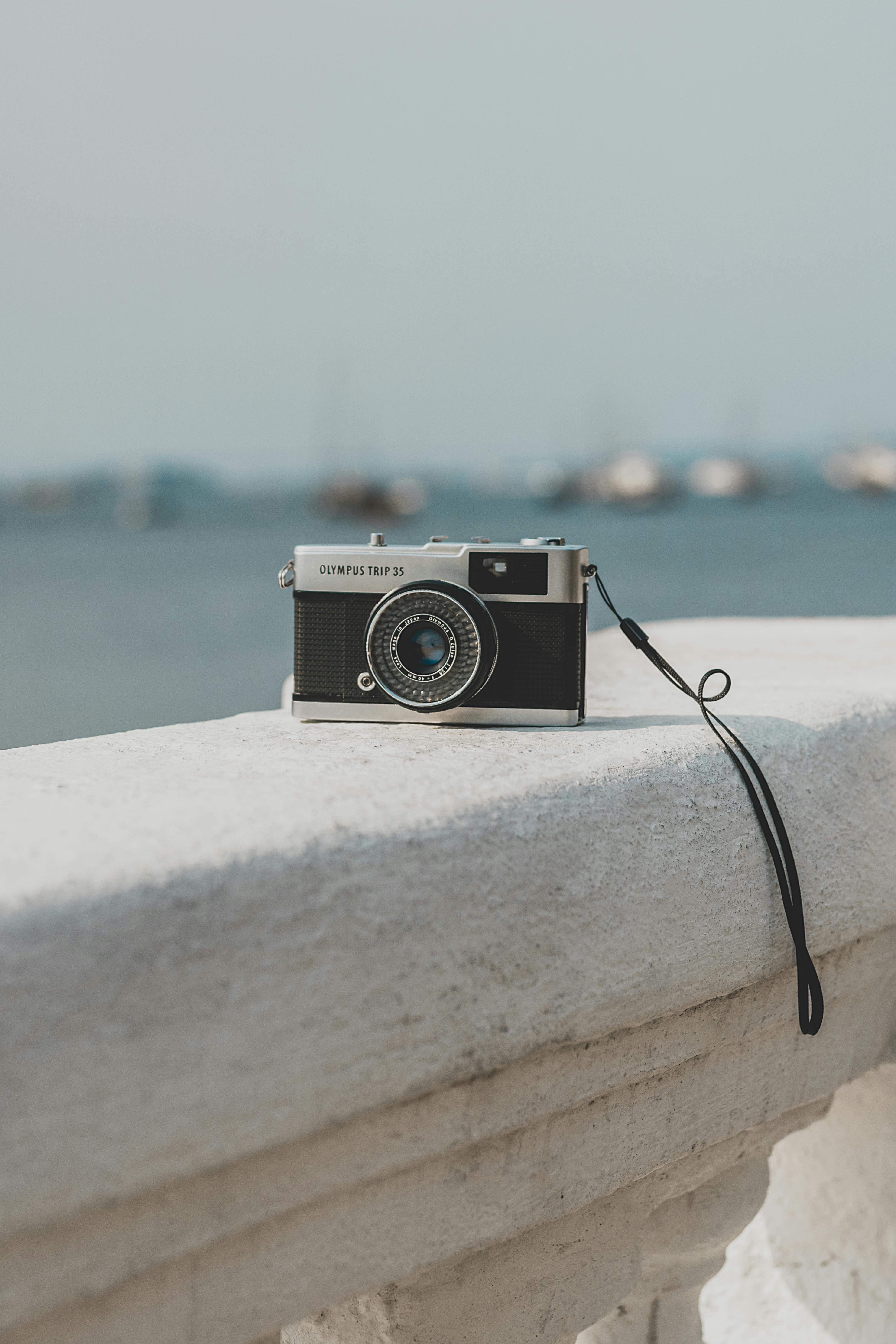 old camera left on stone parapet on quay