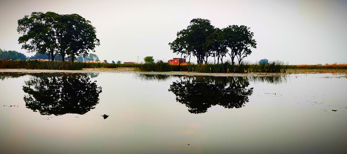 Minimalist living room with large neutral textured art piece hanging above a bench