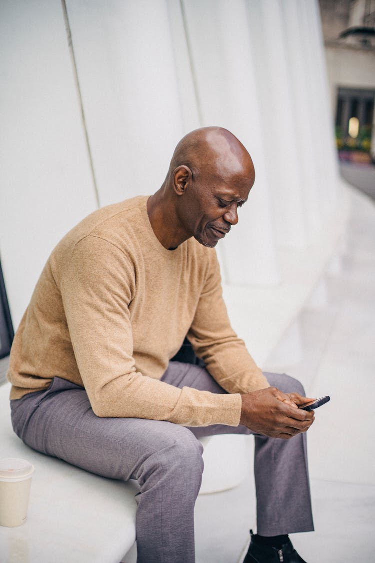 Focused Black Elegant Man Texting On Phone