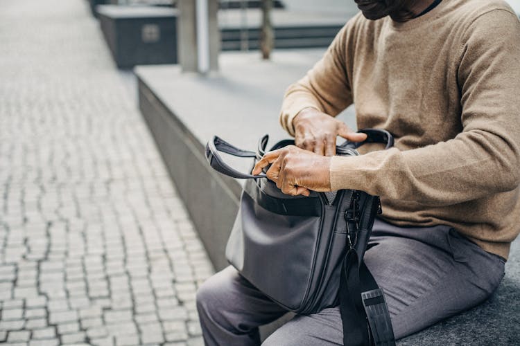 Crop Black Man With Case Bag On Street