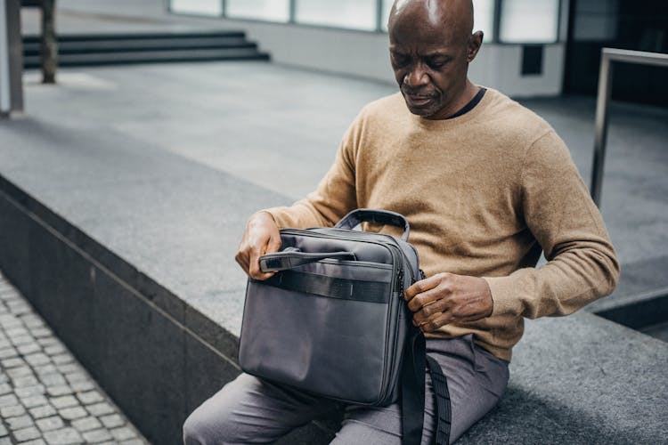 Black Businessman With Case Bag In City