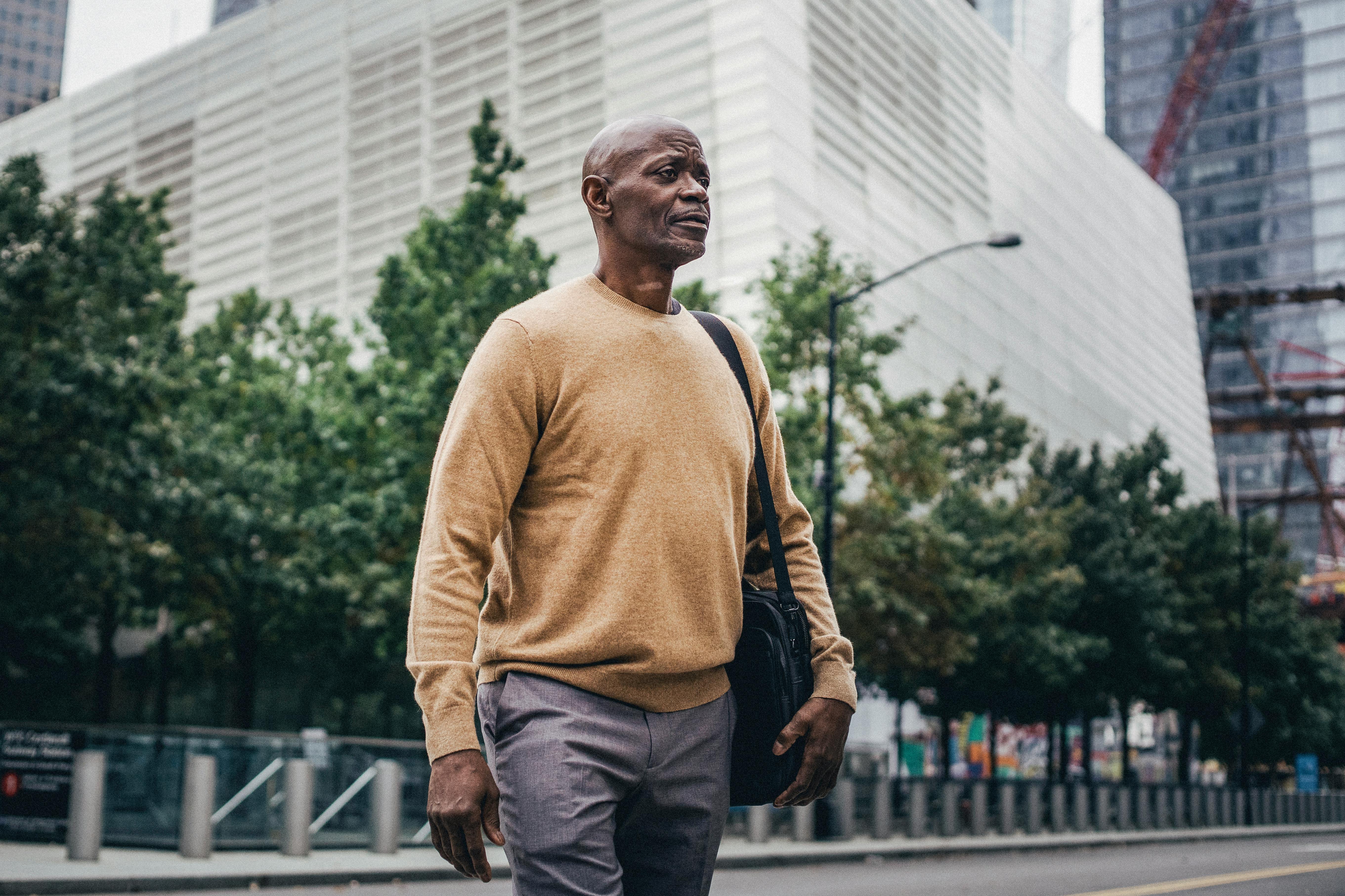 modern black man with bag in downtown