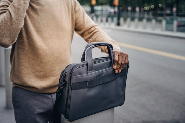 Crop Black Man With Briefcase On Post
