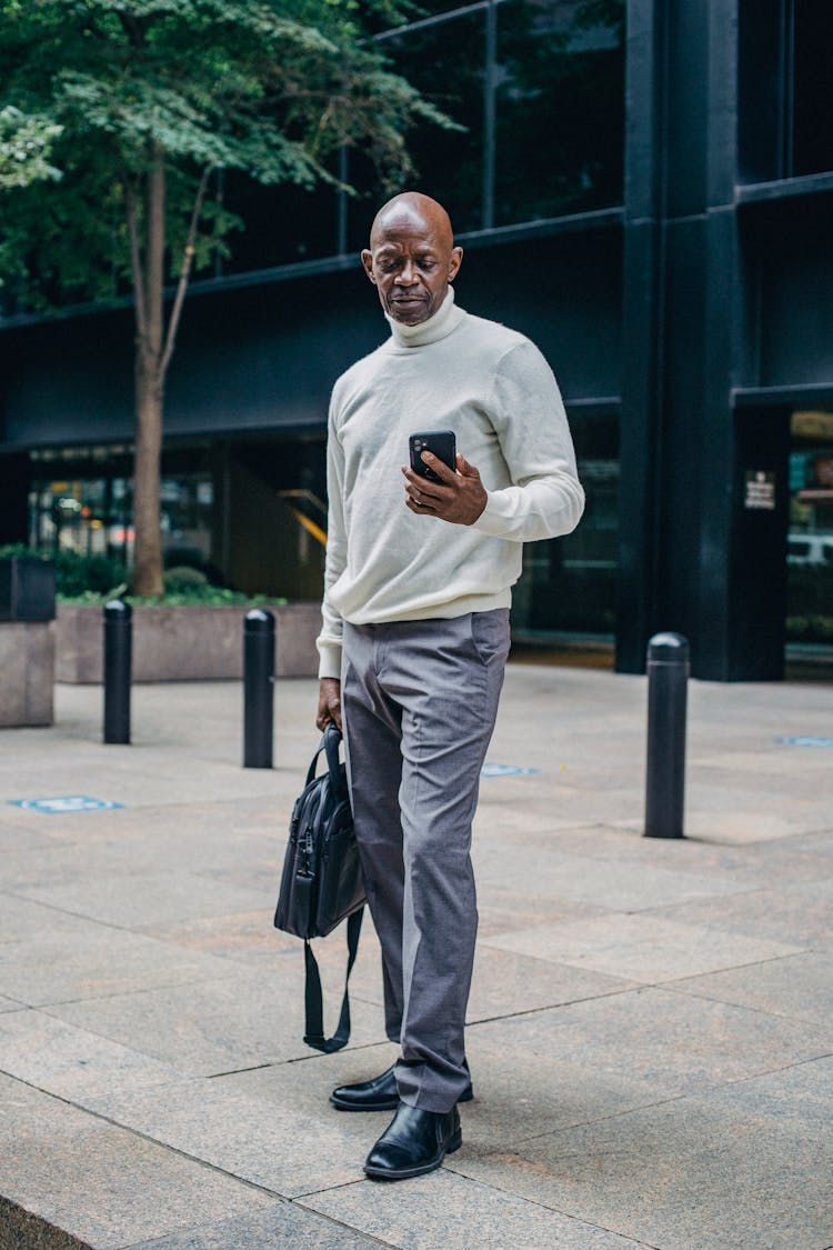 Busy Black Man With Smartphone On Street