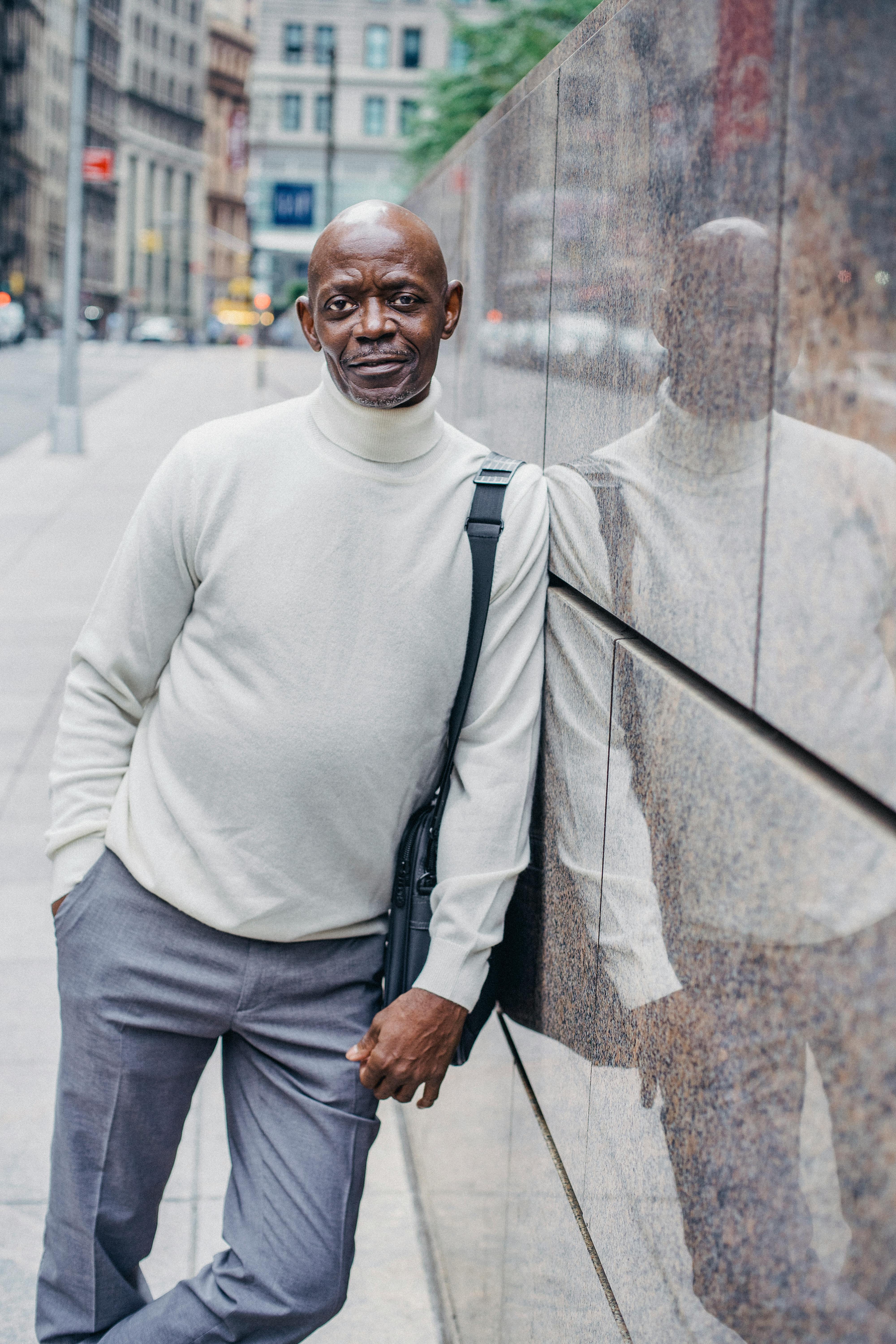 stylish black man near wall on street