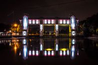 Lighted Building Near Body of Water during Night Time
