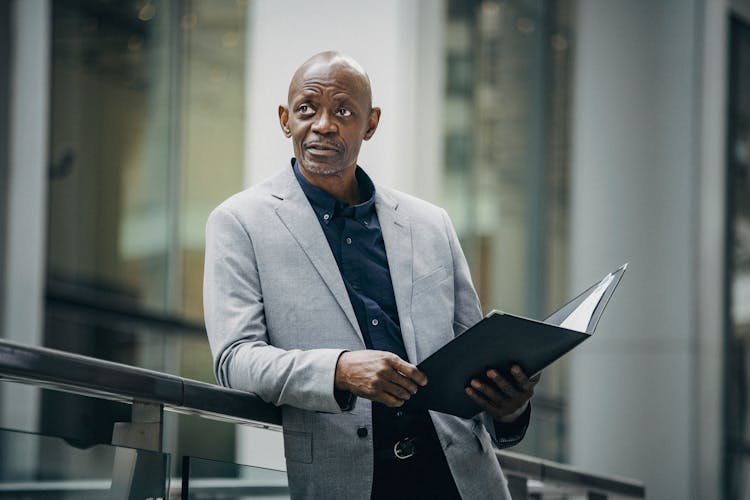 Thoughtful Black Businessman Carrying Document Case