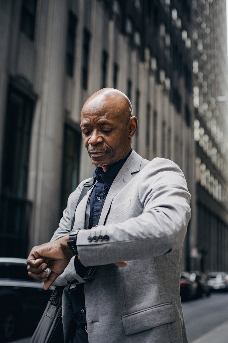 Busy Black Executive Checking Time On Wristwatch On Street