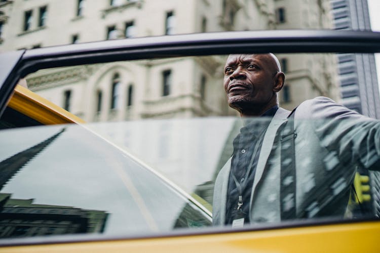 Pondering Black Man Opening Taxi Door