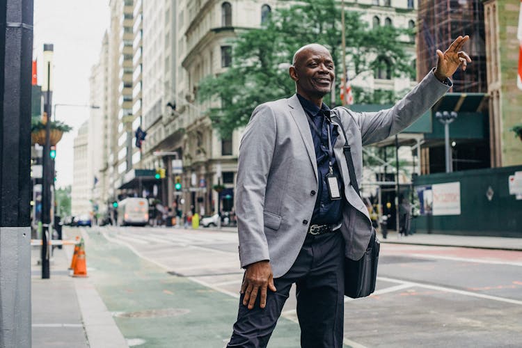 Black Elegant Businessman Catching Transport On Street