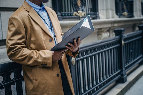 黑人企业家在大街上阅读文件