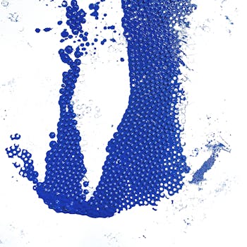 Abstract artistic blue paint texture on a white background featuring contrast and splash effects.