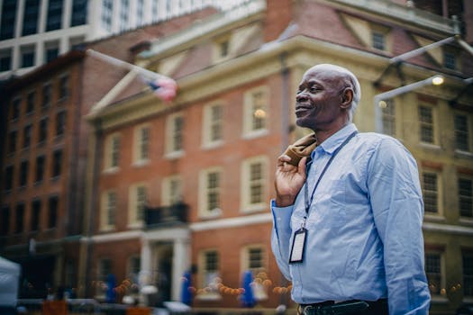African American man in smart attire standing confidently in a bustling urban environment.