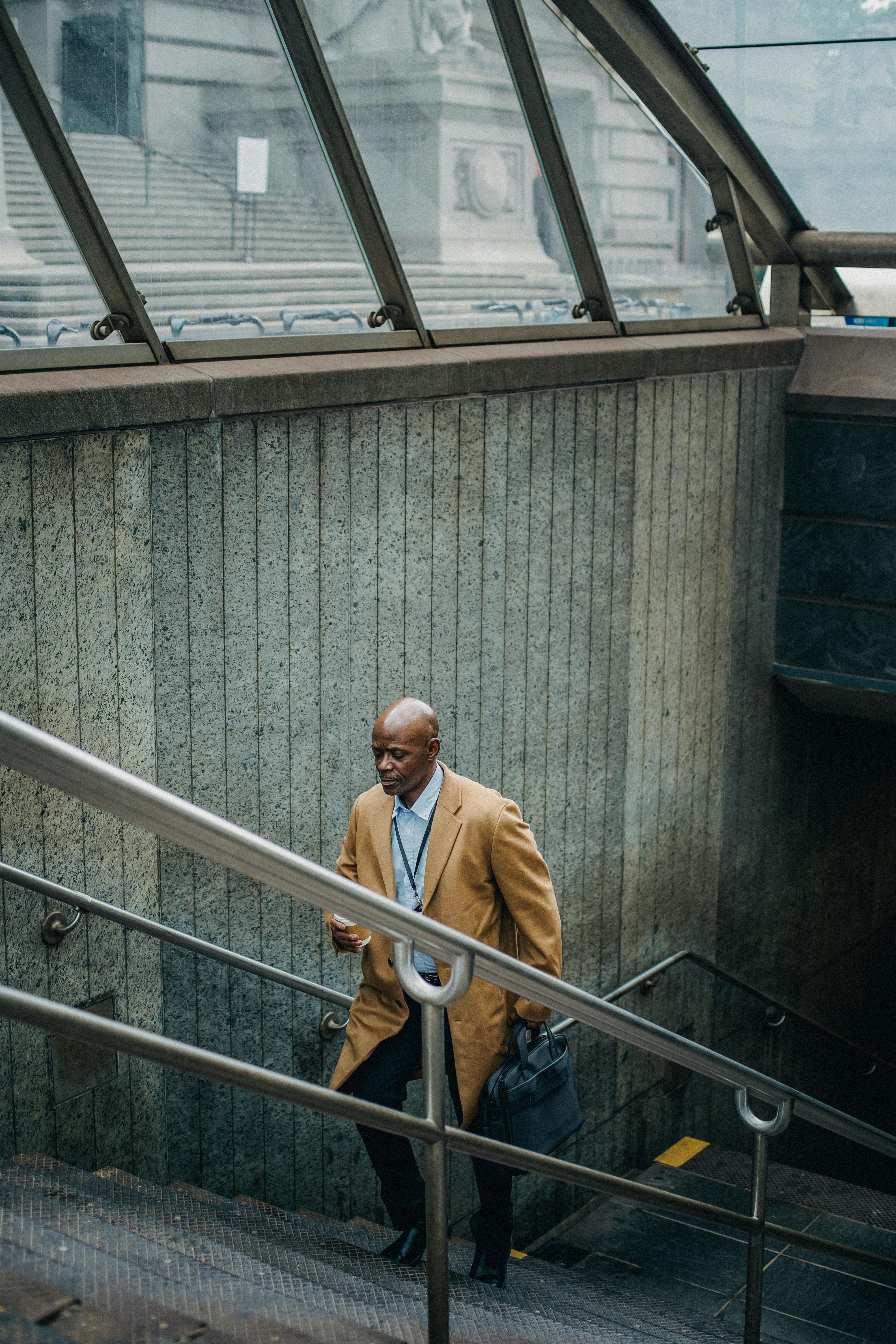 black businessman going upstairs on metro staircase