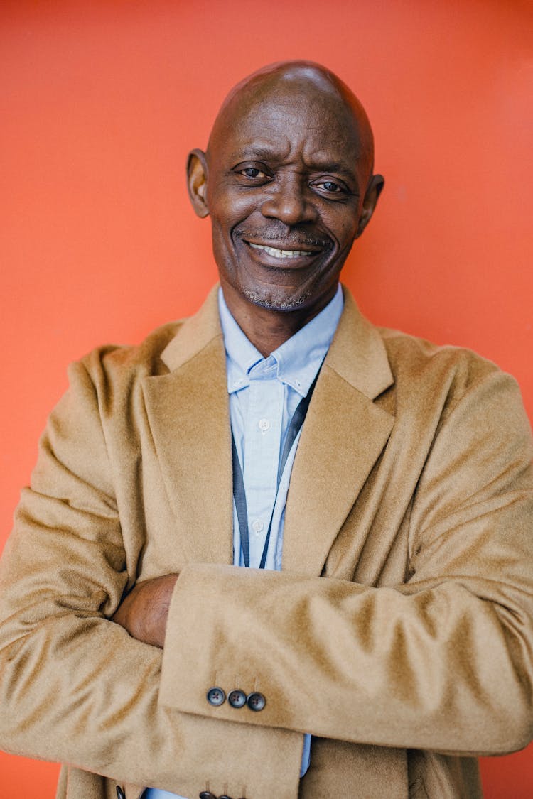 Cheerful Mature Well Dressed Black Businessman With Folded Arms