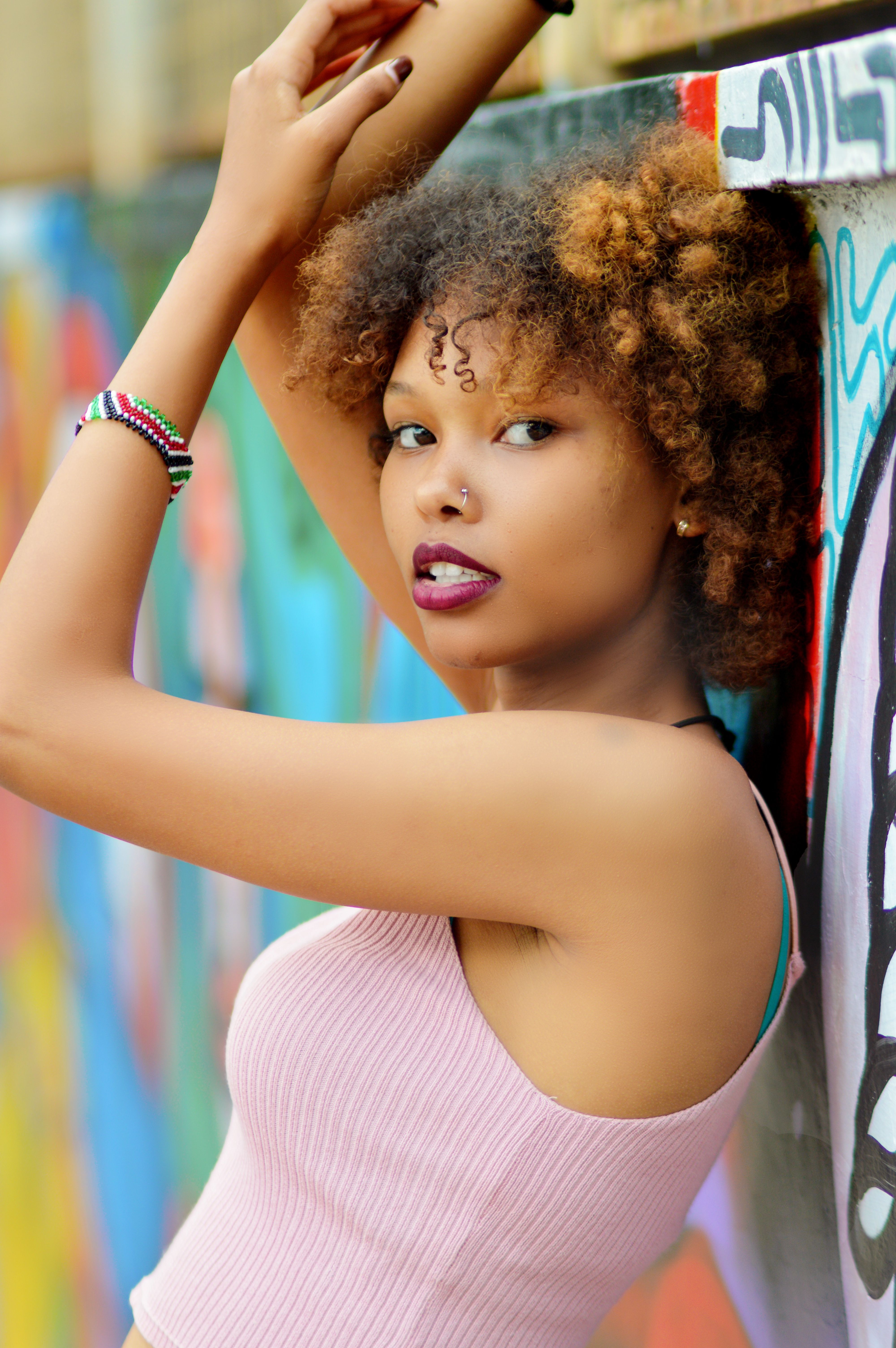 Woman With Curly Hair in a Pink Top · Free Stock Photo