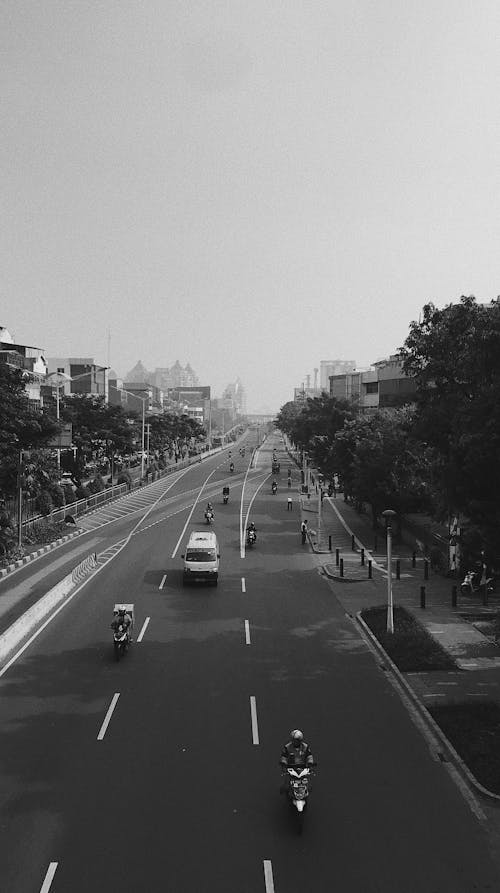 Grayscale Photo of Motorcycles and Van on the Road