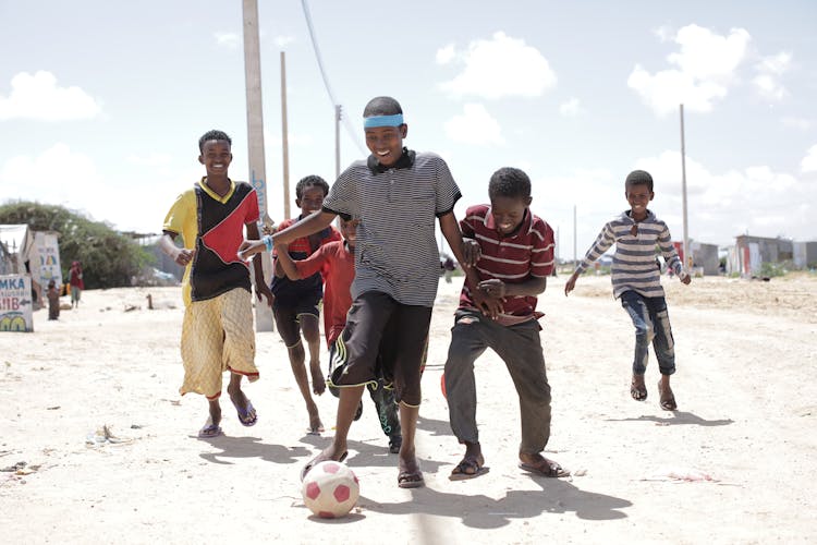 A Group Of Friends Playing Football