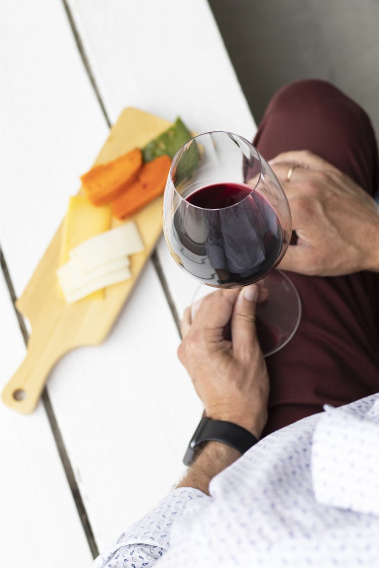 Person Holding Clear Wine Glass With Red Wine