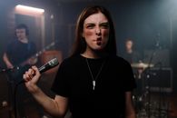 Woman in Black Crew Neck T-shirt Holding Microphone