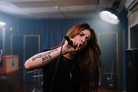 A Tattooed Woman Singing