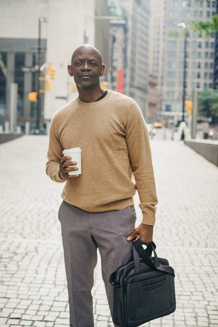 Trendy Mature Black Man Chilling On Street With Cup Of Coffee To Go