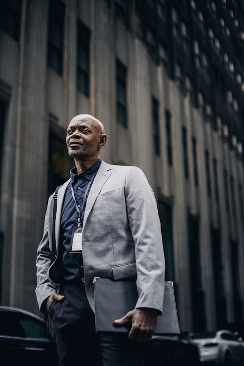 Respectable black businessman standing on city street