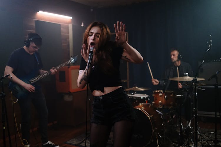 Woman In Black Shirt Singing With Her Band 