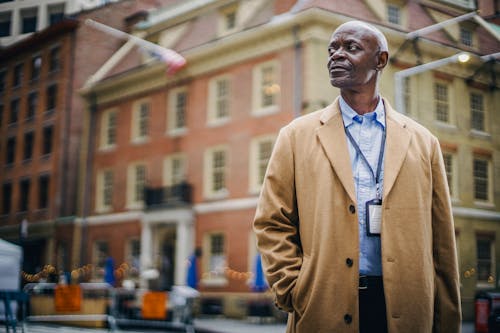 Dreamy ethnic manager against building enjoying city