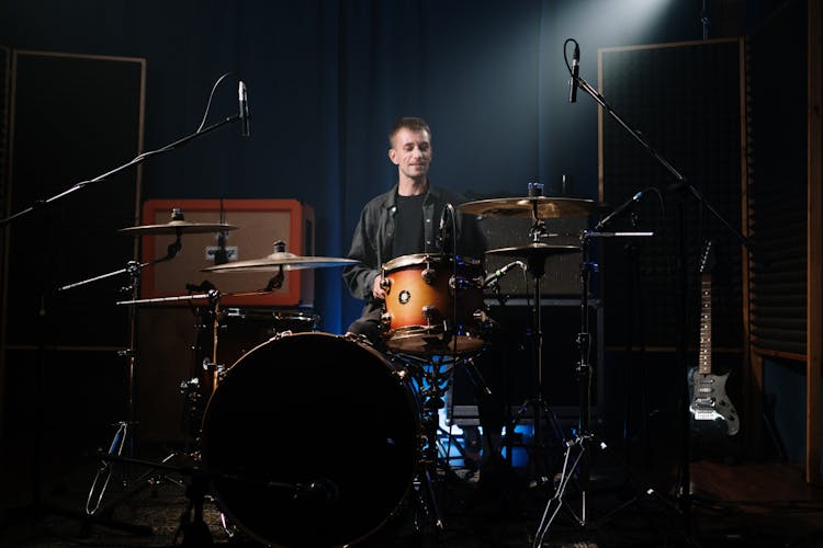 Man In Black Long Sleeves Playing Drum