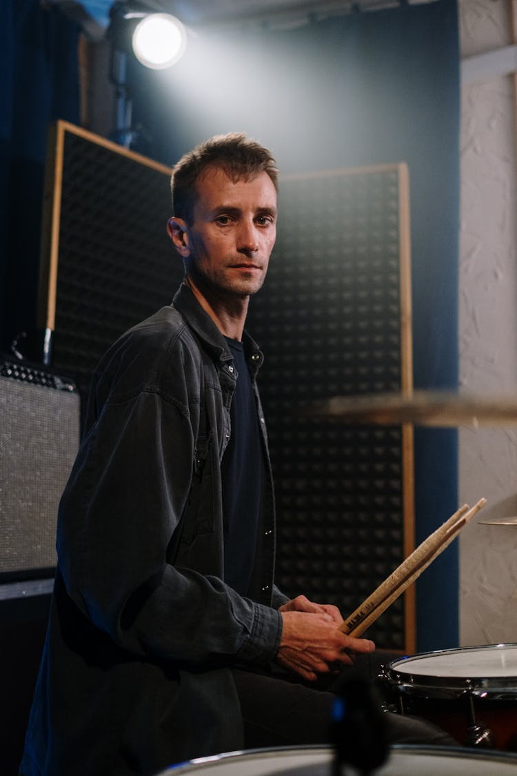 Man In Black Jacket Holding Drum Sticks 