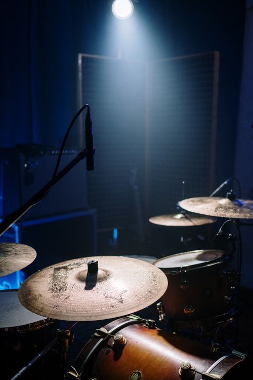 Free Close-up of a drum set in a dimly lit music studio with dramatic lighting. Stock Photo