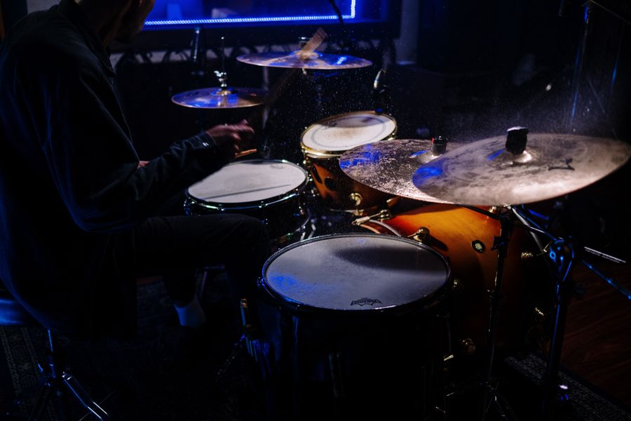 Drummer practicing in a dimly lit music room