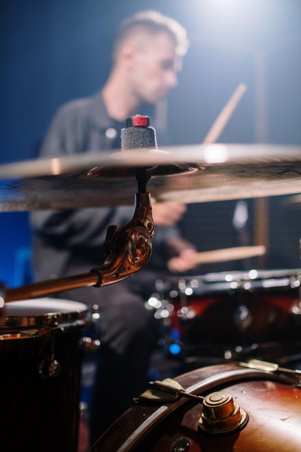 Drummer playing a kit, cymbals in motion — photo by cottonbro studio on Pexels