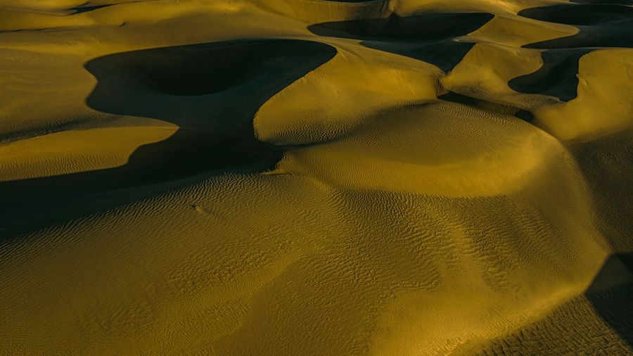 Aerial frame of golden sand dunes at sunset, photo by 光曦 刘 on Pexels
