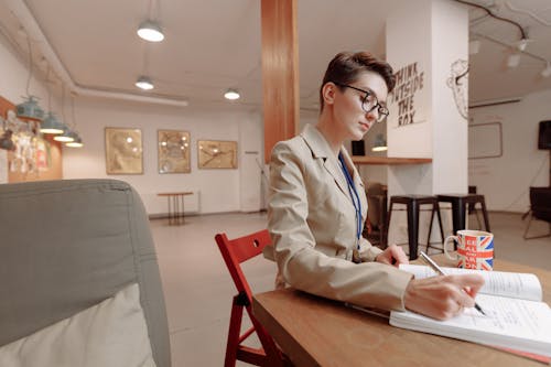 A Short Haired Woman Working while Wearing Eyeglasses