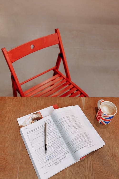 A Book and Coffee on a Wooden Table