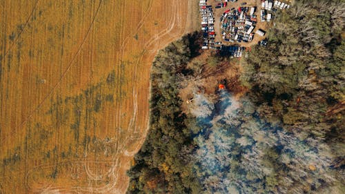 Drone view of car parking near fields and forest