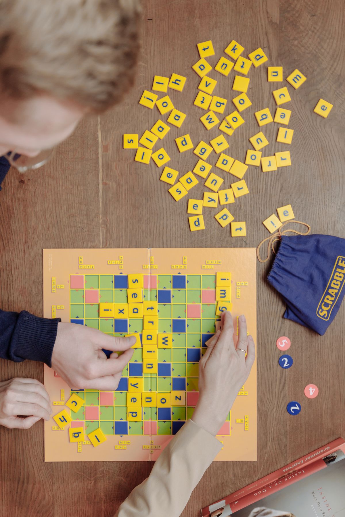 Kids playing a word tile game on board game night