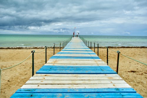 Free Pier on Sandy Beach Stock Photo