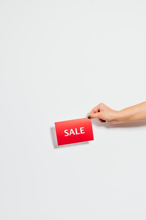 Person Holding Sale Card