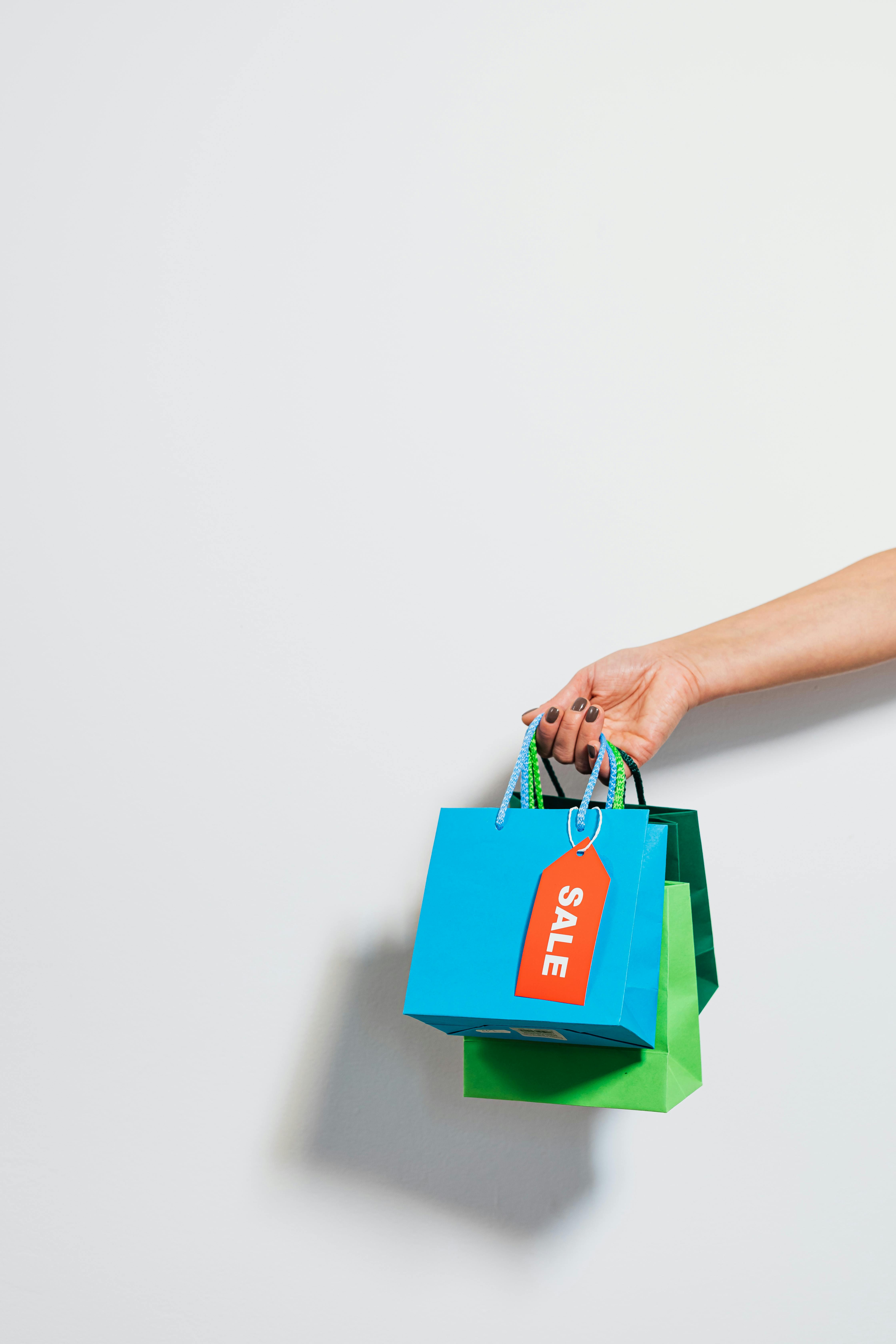 hand holding shopping bags