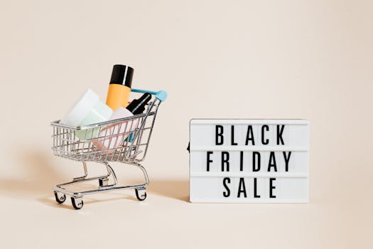 Stylish display of a mini shopping cart and a Black Friday sale sign on a beige background.