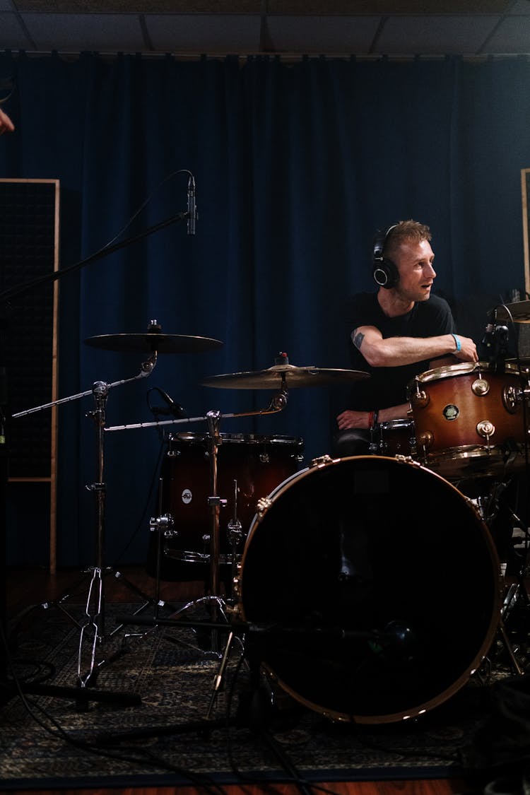 Man With Headphones Playing Drums