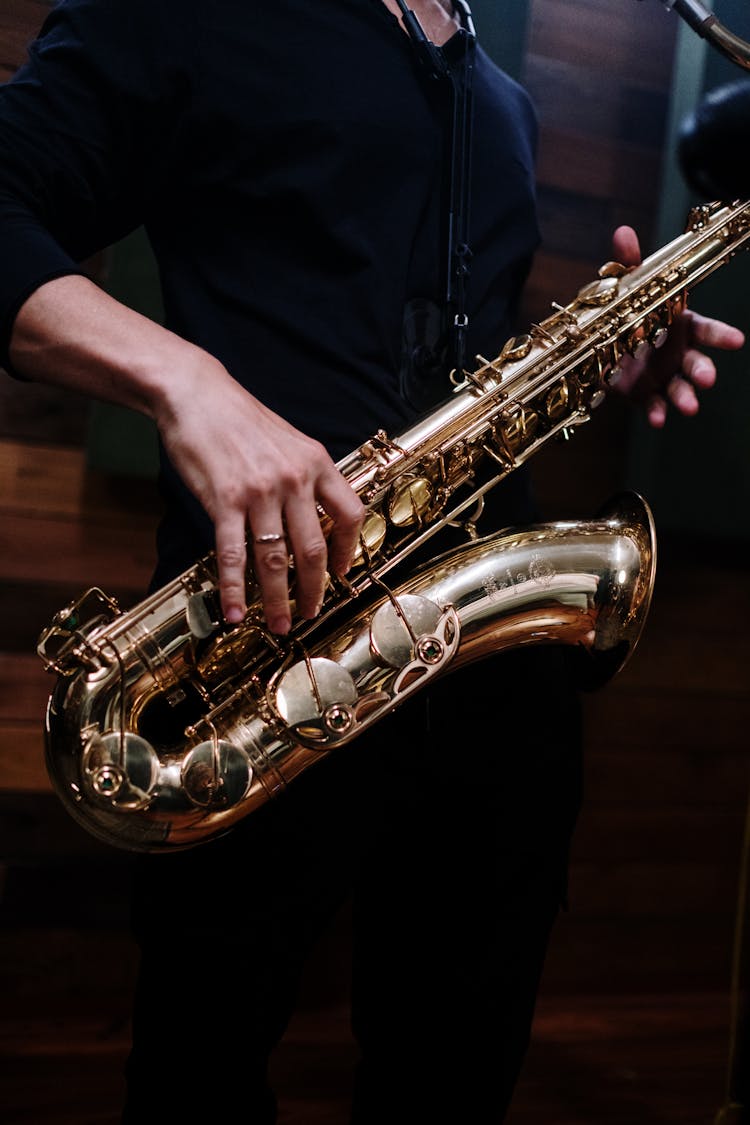 Hands Playing The Golden Saxophone