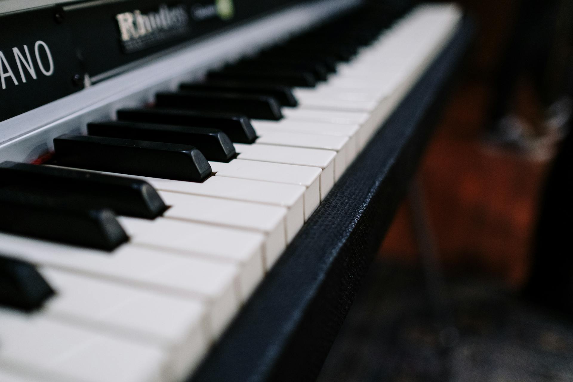 Detailed image of vintage Rhodes piano keys focusing on the keys' texture and design.