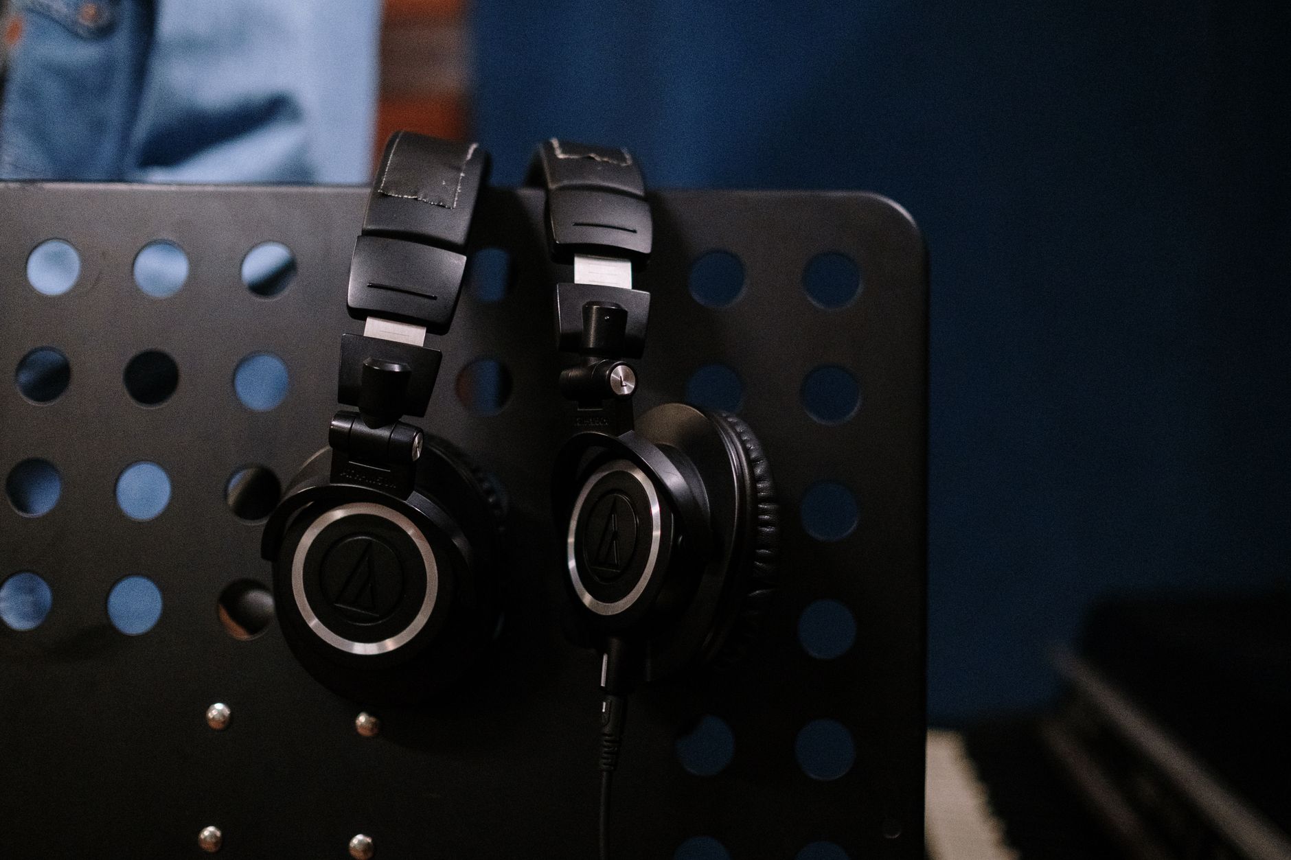 Professional headphones hanging in a studio setting