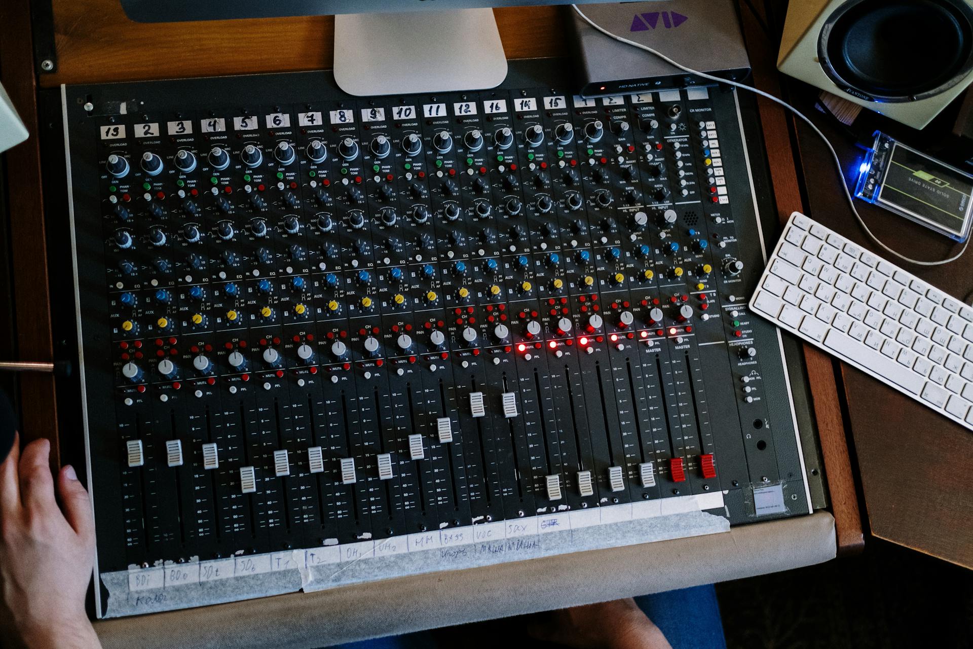 Close-up of audio mixing console in use at a recording studio.