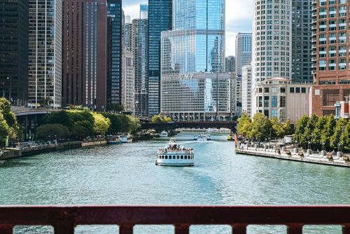 Free Calm river channel with boats located in modern district with skyscrapers in megapolis in daytime Stock Photo